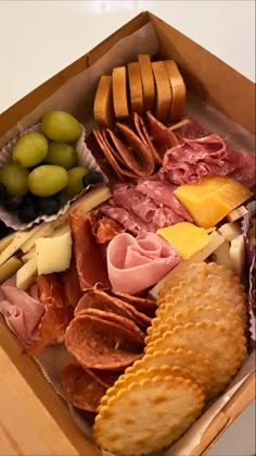 a box filled with different types of cheese and meats