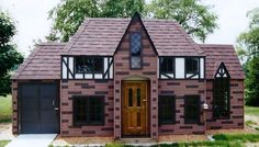 a brick house with two garages on the front and one story above it's roof