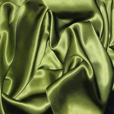 a close up view of a green satin fabric