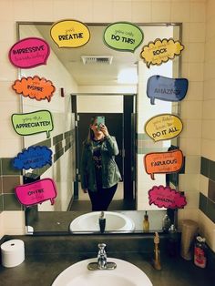 a woman taking a selfie in front of a mirror with speech bubbles on it