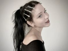 a woman with three hair pins in her hair