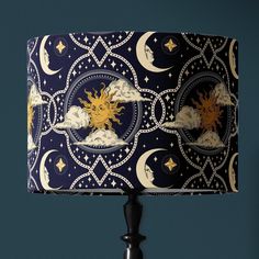 a lampshade with an image of the sun and moon on it, against a blue background