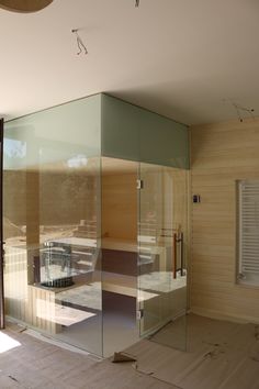 an empty room with glass walls and wooden floors