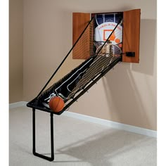 a basketball is in the backboard of a wall mounted basketball hoop that holds a basketball