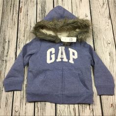 This Is A Nice Sweatshirt That Zips Up The Front For A Girl Done In Blue With An Iridescent & Silver Gap Logo On The Chest. The Body Of The Garment Is Lined With A Very Soft Fleece & Has A Faux Fur Lined Hood. New With Tags. Blue Winter Sweatshirt For Playtime, Gap Hooded Tops For Fall, Gap Outerwear With Adjustable Hood For Fall, Gap Fall Outerwear With Adjustable Hood, Blue Cotton Outerwear By Gap, Fleece Hoodie For Playtime, Blue Hooded Top For Playtime, Winter Hoodie Sweatshirt For Playtime, Fleece Outerwear For Winter Playtime