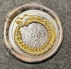 a silver and gold plate with a horse on it