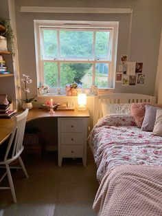 a bedroom with a bed, desk and window