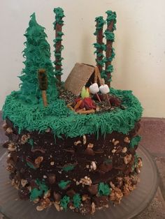 a cake with green frosting and trees on top