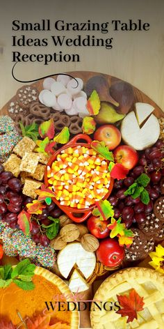 small grazing table idea wedding reception with apples, grapes, pumpkins, corn and crackers