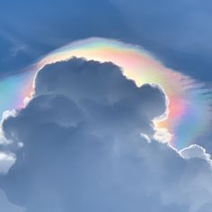 a rainbow in the sky with clouds