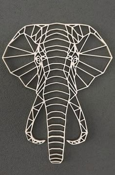 an elephant head made out of wire on a gray background with the word's name below it