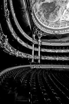 black and white photograph of the interior of a theatre with ornately decorated ceilinging