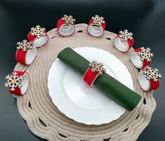 a place setting with red and white decorations