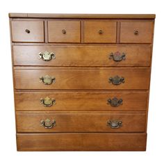 a wooden dresser with brass handles and knobs