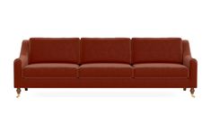 a brown leather couch sitting on top of a white floor next to a wooden frame