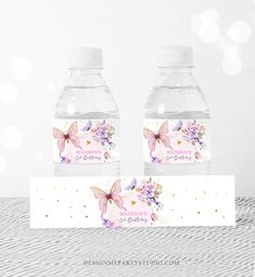 two water bottles with butterfly labels on them