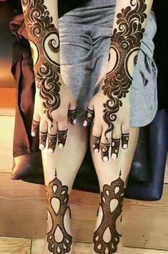 the legs and feet of a woman with henna tattoos