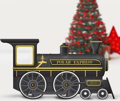 a black and gold train is next to a christmas tree with red stars on it