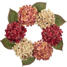 a wreath made out of red and white flowers with green leaves on the front, set against a white background