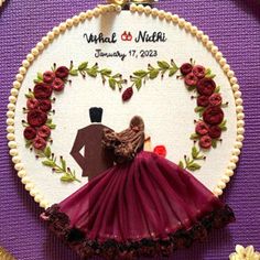 a handmade wedding ornament with a bride and groom in a red dress