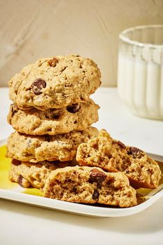 a stack of cookies sitting on top of a plate next to a glass of milk