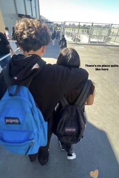 two children with backpacks walking towards an airport