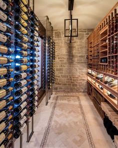 a wine cellar filled with lots of bottles of wine next to a wall of shelves