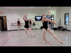 two dancers in black leotards and white masks are dancing on the dance floor