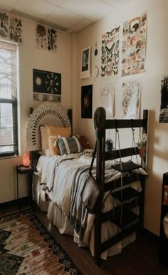 a bed room with a neatly made bed and lots of pictures on the wall above it