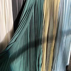 there are many different colored pleated material in this photo and it looks like they have been folded together