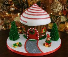 a cupcake decorated with white frosting and candy canes on top of a table