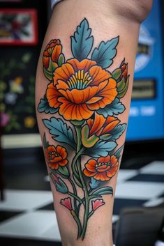 an orange flower tattoo on the leg