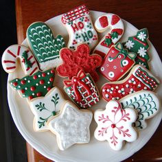 decorated cookies are arranged on a white plate