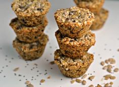 several muffins stacked on top of each other with oats scattered around them