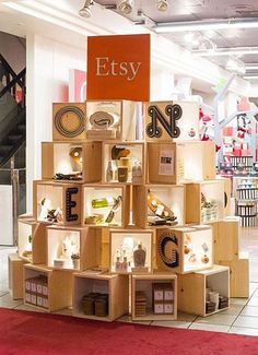 a display in a store filled with lots of different types of items and letters on wooden boxes