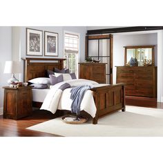 a bedroom scene with focus on the bed and dresser