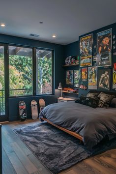 a bedroom with posters on the wall and a large bed in front of a window