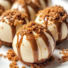 chocolate covered desserts on a white plate with crumbs