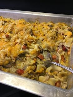 a casserole dish with noodles, meat and vegetables in it is ready to be eaten