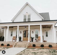 a white house with porches and chairs on the front steps is featured in an instagram