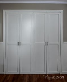 an empty room with white closets and wood floors