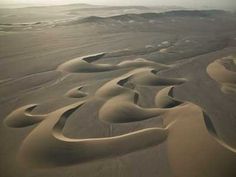 an aerial view of sand dunes in the desert