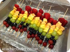 fruit kabobs are arranged on skewers with grapes and strawberries