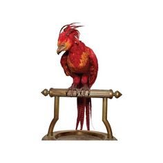 a red and yellow bird sitting on top of a metal stand with two legs in front of it