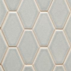 a white tile wall with hexagonal pattern