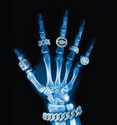 a skeleton hand with rings and bracelets on it