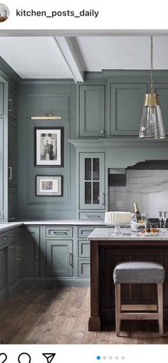 an image of a kitchen setting with green cabinets and marble counter tops on instagram