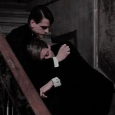 a man and woman are hugging on the stairs