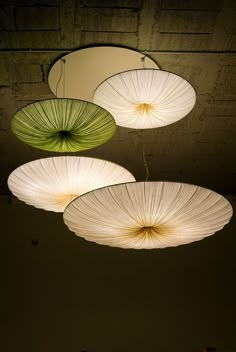 three circular lights hanging from the ceiling in a room