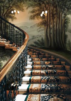 an artistic staircase painted with trees and mountains on the wall, along with decorative rugs